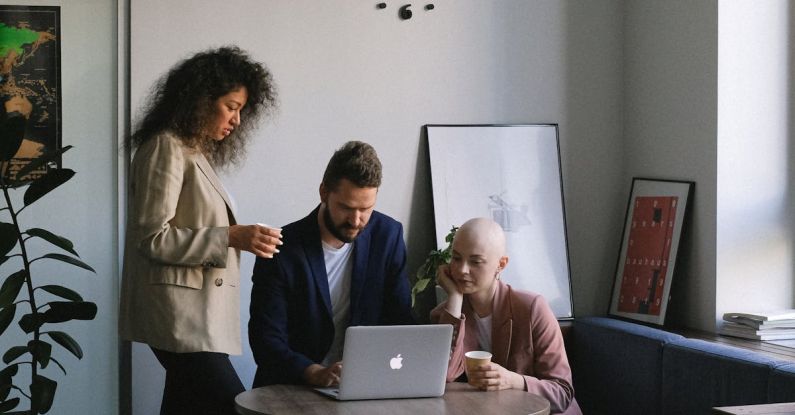 Discussion Clock - Diverse coworkers using laptop and speaking about job