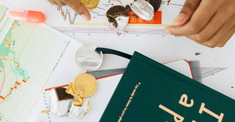 Books Graph - Person Holding a Gold Chocolate Coin on the Table with a Green Book