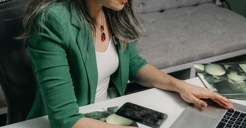 Typing Laptop - Woman Sitting at a Desk and Typing on a Laptop