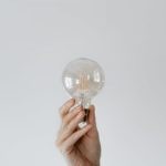 Idea Bulb - Anonymous female showing light bulb