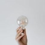 Idea Bulb - Anonymous female showing light bulb