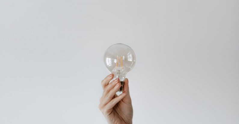 Idea Bulb - Anonymous female showing light bulb