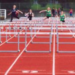 Hurdles - Shallow Focus Photo of People Playing Track and Field