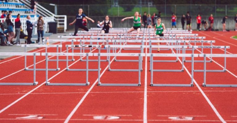 Hurdles - Shallow Focus Photo of People Playing Track and Field