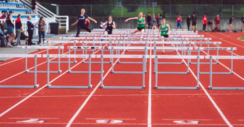 Hurdles - Shallow Focus Photo of People Playing Track and Field