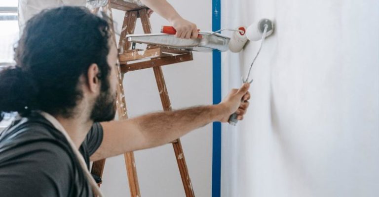 Ladder Success - A Couple Painting The Wall