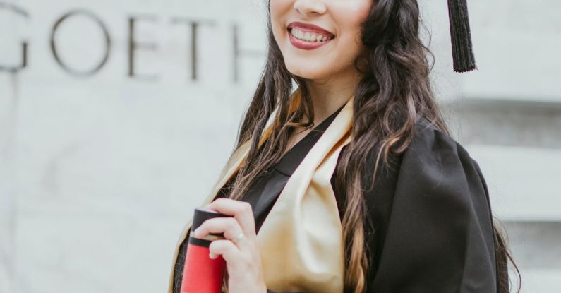 Graduation Cap - Selective Focus Photo of Smiling Woman in Black Academic Dress Holding Diploma Posing