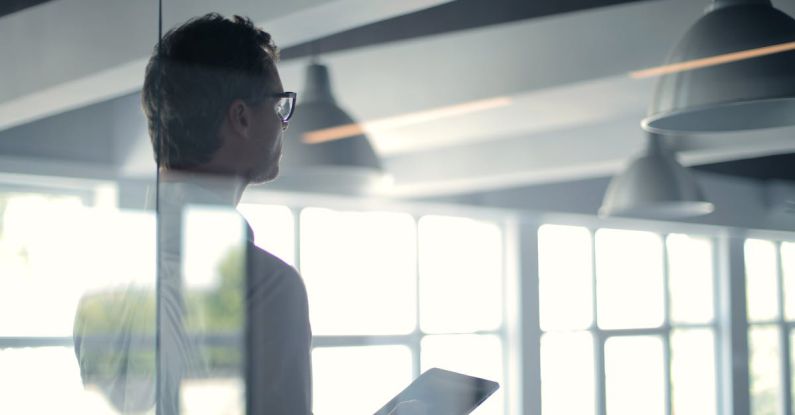 CEO Office - Formal man with tablet giving presentation in office