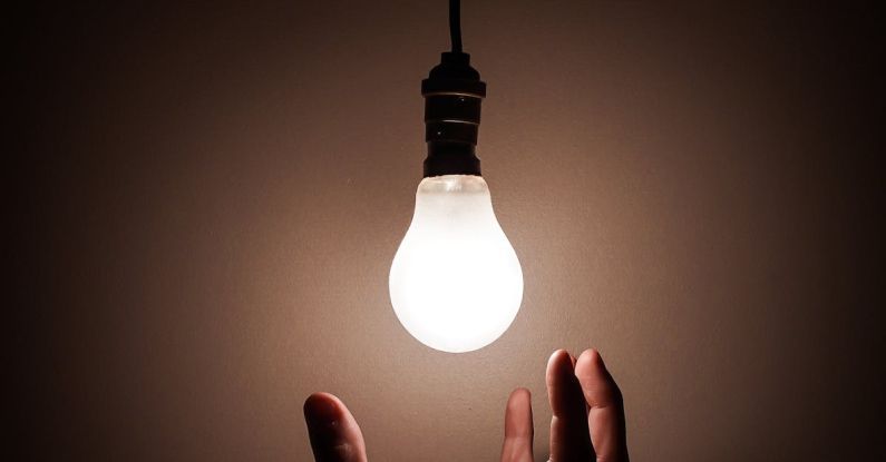 Light Bulb Patent - Person Holding White Light Bulb