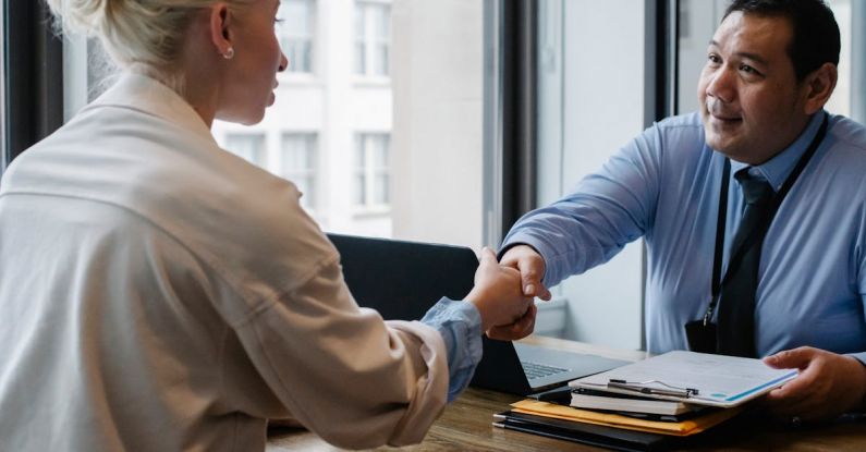 Resume Tips - Ethnic businessman shaking hand of applicant in office