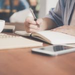 Internship Application - Woman Writing on a Notebook Beside Teacup and Tablet Computer