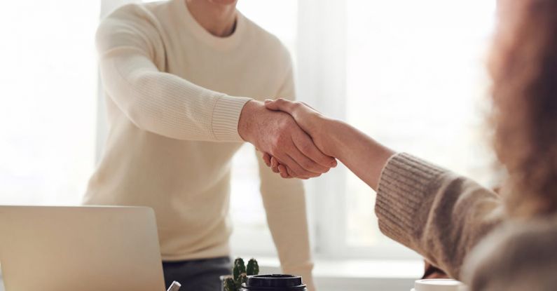 Job Fair - Man and Woman Near Table