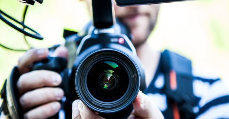 Interview Follow-up - Person Holding Canon Dslr Camera Close-up Photo