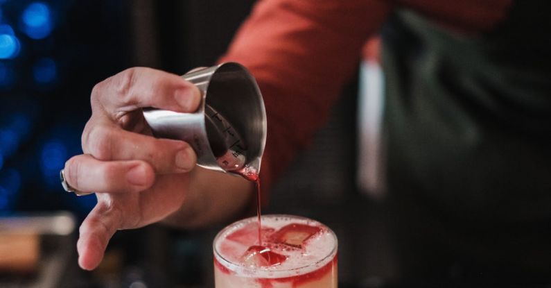 Interview Preparation - A bartender pouring a drink into a glass