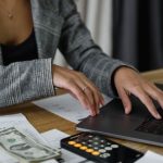 Salary Negotiation - A Woman in Plaid Blazer Using Her Laptop