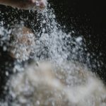 Job Board - Crop baker scattering powdered flour on table