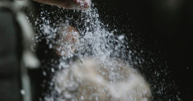 Job Board - Crop baker scattering powdered flour on table