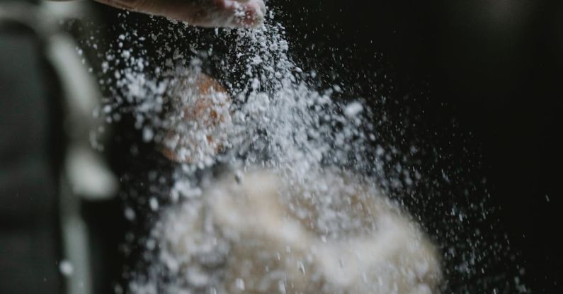 Job Board - Crop baker scattering powdered flour on table